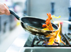 Touching the handle of a hot pot from the stove