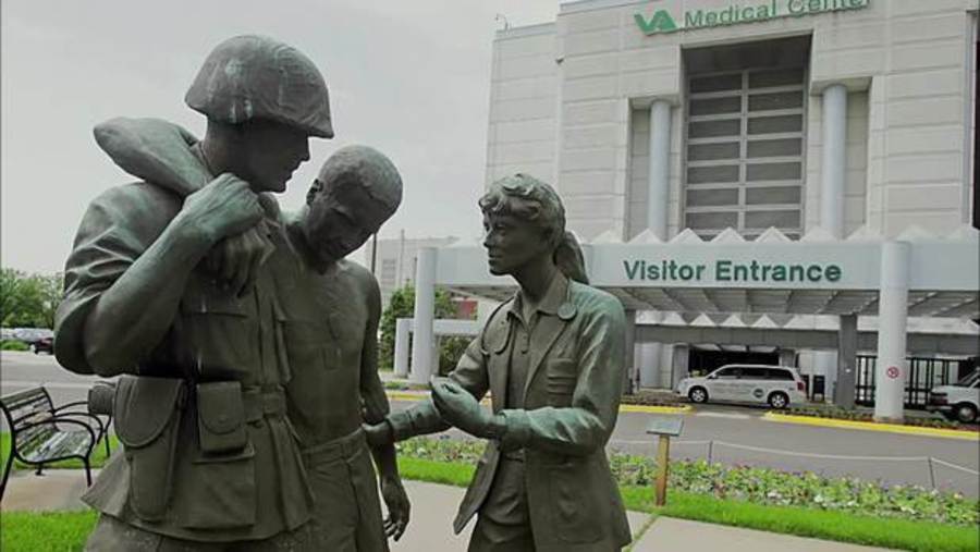 Statue of 3 people in front of VA Medical Center Building